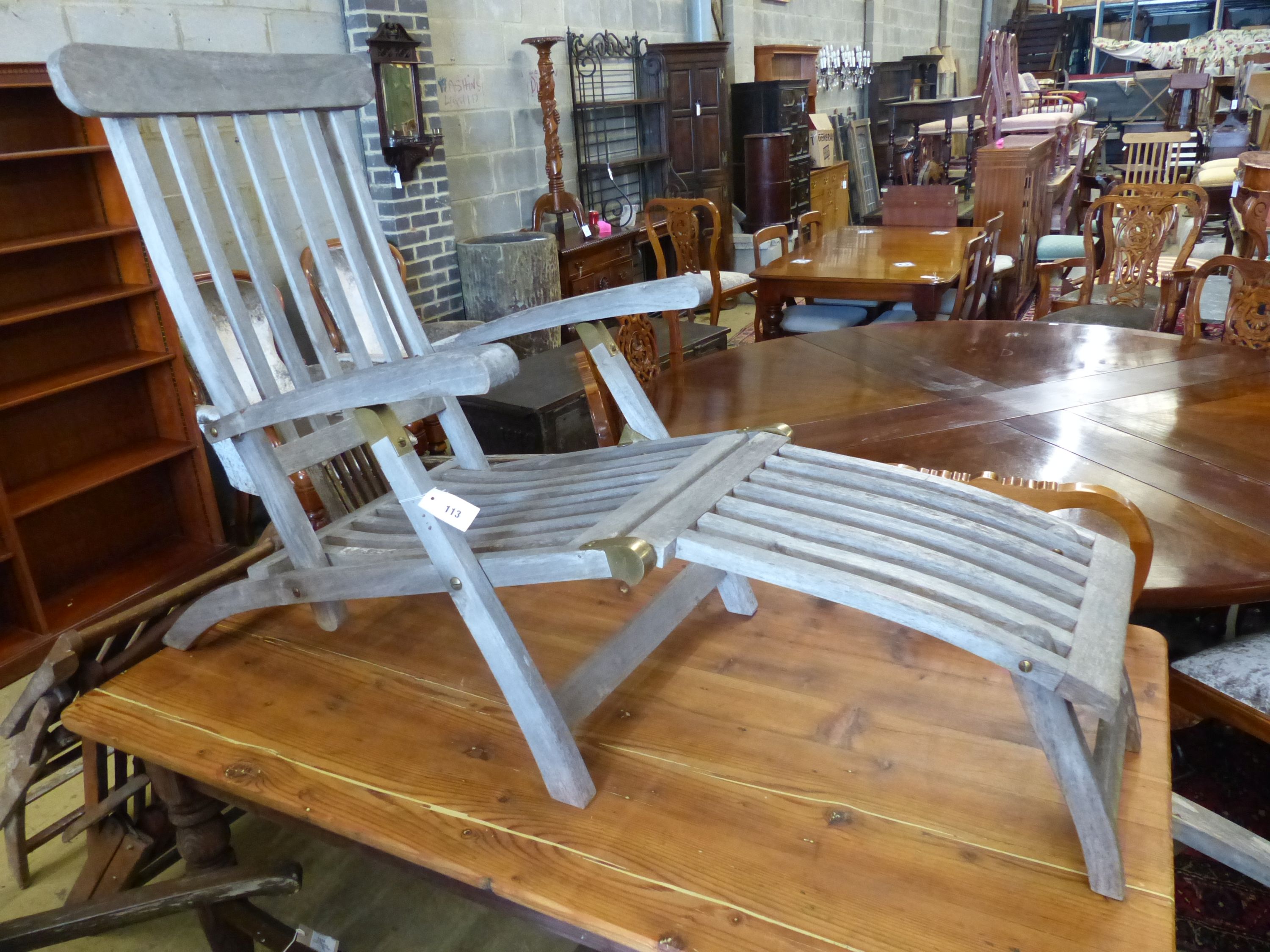 A pair of weathered teak garden steamer chairs, width 59cm, depth 150cm, height 98cm